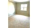 Bright bedroom featuring neutral walls, carpet flooring, and a window that allows for great light at 10933 Harrowfield Rd, Charlotte, NC 28226