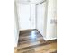 Bright entryway with wood-look floors, white door, and built-in storage at 10933 Harrowfield Rd, Charlotte, NC 28226
