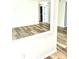 Open living area with wood-look floors and access to other rooms at 10933 Harrowfield Rd, Charlotte, NC 28226