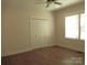 Bedroom with ceiling fan, double door closet, and large window at 1120 Cedar St, Mount Holly, NC 28120