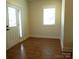 Versatile flex room with neutral paint, natural light, and door, suitable for a home office or guest room at 1120 Cedar St, Mount Holly, NC 28120