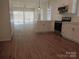 Bright kitchen featuring white cabinetry, stainless steel appliances, island and an open floor plan at 1120 Cedar St, Mount Holly, NC 28120