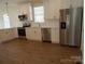 Bright kitchen featuring stainless steel appliances, white cabinets, subway tile backsplash, and sleek countertops at 1120 Cedar St, Mount Holly, NC 28120