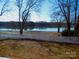 The yard is fenced and leads to a lake with a beach at 1120 Cedar St, Mount Holly, NC 28120