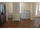 Convenient laundry room with washer, dryer, utility sink, and exterior access, enhancing functionality at 1120 Cedar St, Mount Holly, NC 28120