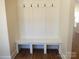 Organized mudroom featuring hooks and bench seating, providing a practical and stylish entryway solution at 1120 Cedar St, Mount Holly, NC 28120