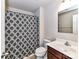 Bathroom includes a vanity, toilet, mirror, and shower with patterned curtain at 1128 Tangle Ridge Se Dr, Concord, NC 28025