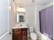 Bathroom with a vanity, toilet, and shower/tub combination at 1128 Tangle Ridge Se Dr, Concord, NC 28025