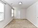 Carpeted bedroom with a neutral paint, closet, and a window with blinds at 1128 Tangle Ridge Se Dr, Concord, NC 28025