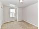 Carpeted bedroom with a neutral paint, and a window with blinds at 1128 Tangle Ridge Se Dr, Concord, NC 28025
