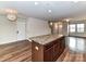 View of the kitchen with island, leading to the living area and stairs at 1128 Tangle Ridge Se Dr, Concord, NC 28025