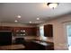 This kitchen features dark cabinets, a stainless steel microwave, and recessed lighting at 1128 Tangle Ridge Se Dr, Concord, NC 28025