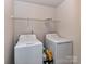 Laundry room features a washer, dryer, and shelves at 1128 Tangle Ridge Se Dr, Concord, NC 28025