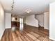 Open-concept living space featuring wood floors and a view of the kitchen at 1128 Tangle Ridge Se Dr, Concord, NC 28025