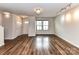 Bright and airy living room with beautiful wood floors and modern lighting at 1128 Tangle Ridge Se Dr, Concord, NC 28025