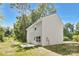 The rear exterior of this two-story home has light gray vinyl siding and a small patio at 114 I K Beatty St, Charlotte, NC 28214