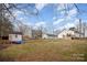 Wide shot of the backyard with a storage shed and plenty of yard at 1140 Roberts St, China Grove, NC 28023