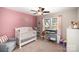 Charming bedroom with pink accents, featuring a crib and changing table near a window at 1140 Roberts St, China Grove, NC 28023
