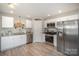 Updated kitchen with stainless steel appliances, white cabinets, and a modern aesthetic at 1140 Roberts St, China Grove, NC 28023