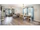 Bright living room with a comfortable sectional sofa and a rustic dining table set near blue curtained windows at 1140 Roberts St, China Grove, NC 28023