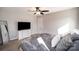 Spacious main bedroom featuring a ceiling fan, a dresser with a TV, and ample natural light at 1140 Roberts St, China Grove, NC 28023