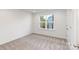 Clean, bright bedroom with a large window overlooking a beautiful exterior at 118 I K Beatty St, Charlotte, NC 28214