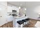 Well-equipped kitchen island features seating, pendant lights, and stainless steel appliances at 118 I K Beatty St, Charlotte, NC 28214