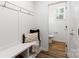 Mudroom showcases convenient bench with storage, coat hooks, and a view into the powder room at 118 I K Beatty St, Charlotte, NC 28214