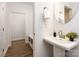 Well-lit powder room with modern sink and fixtures adjacent to the mudroom in neutral color palette at 118 I K Beatty St, Charlotte, NC 28214