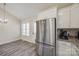 Kitchen with stainless steel refrigerator, granite countertops, white cabinets, and breakfast nook at 1218 Calhoun St, Rock Hill, SC 29732