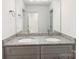 Stylish bathroom featuring double sinks, granite countertops, modern fixtures, and ample cabinet space at 122 I K Beatty St, Charlotte, NC 28214