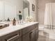 Clean bathroom with dark vanity, bathtub, and patterned shower curtain at 14543 Crosswater Ln, Charlotte, NC 28278