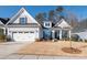 Two-story home with gray siding, landscaping, and a two-car garage at 14543 Crosswater Ln, Charlotte, NC 28278
