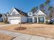 Two-story home with gray siding, white columns and landscaping at 14543 Crosswater Ln, Charlotte, NC 28278