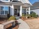 Welcoming front entry with stone accents and landscaping at 14543 Crosswater Ln, Charlotte, NC 28278
