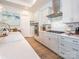 White kitchen with stainless steel appliances and a large sink at 14543 Crosswater Ln, Charlotte, NC 28278