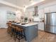 Modern kitchen with a large island, stainless steel appliances, and white cabinets at 14543 Crosswater Ln, Charlotte, NC 28278