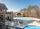 Community pool and spa with surrounding deck and clubhouse at 14543 Crosswater Ln, Charlotte, NC 28278