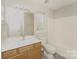 Clean bathroom with tub, toilet, and vanity with wood cabinets at 1614 Hardy Dr, Rock Hill, SC 29732