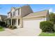 Two-story house with beige siding, a dark-colored front door, and a two-car garage at 1614 Hardy Dr, Rock Hill, SC 29732