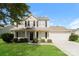 Two-story house with beige siding, a dark-colored front door, and a two-car garage at 1614 Hardy Dr, Rock Hill, SC 29732
