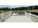 A well-maintained wooden deck overlooks a tranquil pond and lush green landscape at 2510 Lentz Rd, China Grove, NC 28023