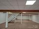 Large basement with brick floors, white walls, white ceilings, and visible support beams at 2510 Lentz Rd, China Grove, NC 28023
