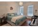 Cozy bedroom with a decorative chandelier and plenty of natural light from two windows at 2510 Lentz Rd, China Grove, NC 28023