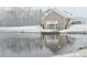 Picturesque home with a walkout basement leading to a pond, reflecting winter's snowy scene at 2510 Lentz Rd, China Grove, NC 28023