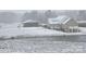Serene winter scene of a brick home with a pond, complemented by a detached garage and snow-covered landscape at 2510 Lentz Rd, China Grove, NC 28023