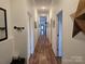 Long, bright hallway features hard wood floors and white trim for a classic look at 2510 Lentz Rd, China Grove, NC 28023