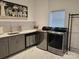 Modern laundry room equipped with stainless steel appliances, ample counter space and storage at 2510 Lentz Rd, China Grove, NC 28023