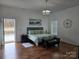 Main bedroom with light, neutral colors, hardwood floors, and access to the back deck at 2510 Lentz Rd, China Grove, NC 28023