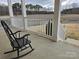 Inviting porch with a rocking chair overlooking a serene view of the water and wooded landscape at 2510 Lentz Rd, China Grove, NC 28023